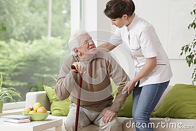 Nurse helping elderly man Stock Photo