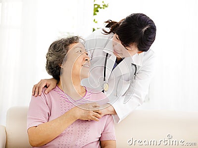 Nurse holding hand of senior woman in rest home Stock Photo