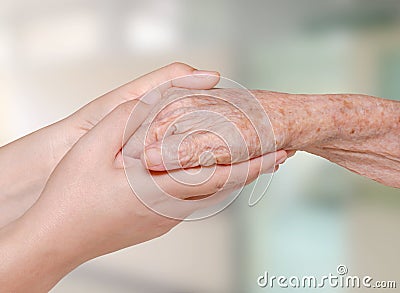 Nurse holding old patient hand Stock Photo