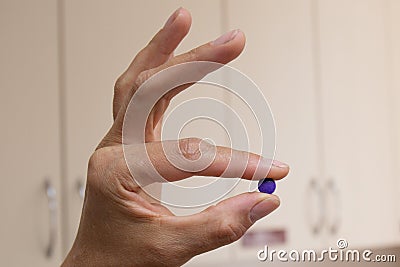 The nurse holds the plaque indication tablets in a pinch Stock Photo