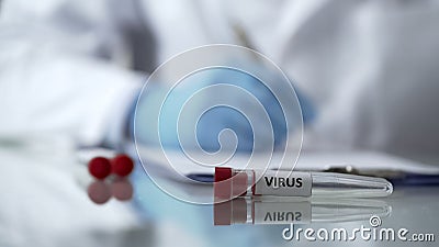 Nurse inserting results of tests for virus antibodies blood into card, epidemic Stock Photo
