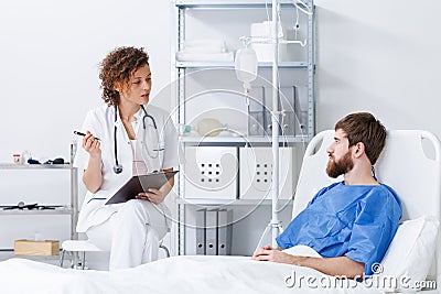 Nurse interviewing patient in hospital Stock Photo