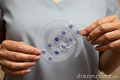 Nurse keeps purple disclosing tablets Stock Photo