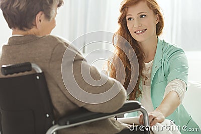 Nurse looking at elder woman Stock Photo