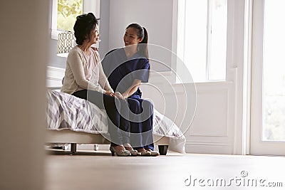 Nurse Making Home Visit To Senior Woman Stock Photo