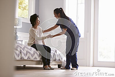 Nurse Making Home Visit To Senior Woman Stock Photo