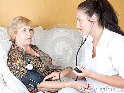 Nurse measures blood pressure of an elderly woman Stock Photo