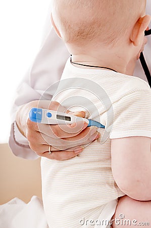 Nurse measures the temperature of a baby Stock Photo