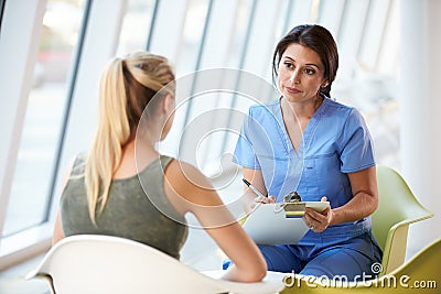 Nurse Meeting With Teenage Girl In Modern Hospital Stock Photo