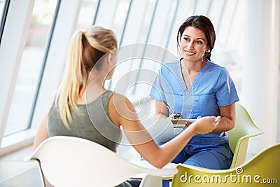 Nurse Meeting With Teenage Girl In Modern Hospital Stock Photo