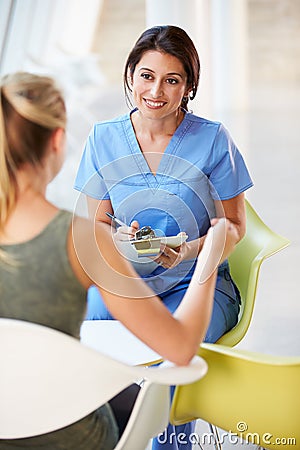 Nurse Meeting With Teenage Girl In Modern Hospital Stock Photo