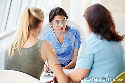 Nurse Meeting With Teenage Girl And Mother Stock Photo