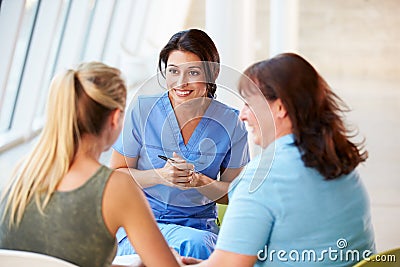 Nurse Meeting With Teenage Girl And Mother Stock Photo