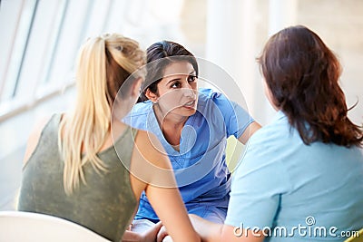 Nurse Meeting With Teenage Girl And Mother In Hospital Stock Photo