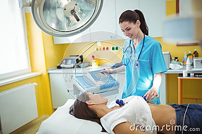Nurse performing an electrocardiogram test on the patient Stock Photo