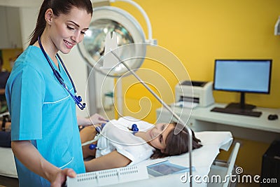 Nurse performing an electrocardiogram test on the patient Stock Photo