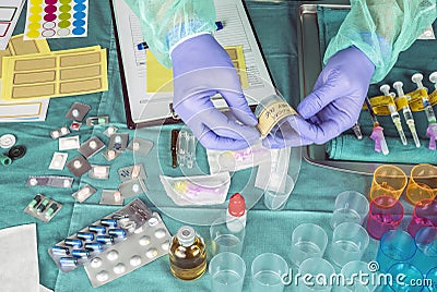 Nurse preparing hospital medication, placing dose medicine in glass monodose Stock Photo