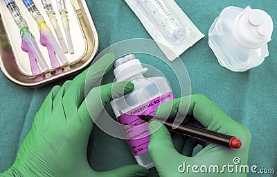 Nurse preparing hospital medication, Write sick data to medical assignment labels, conceptual image Stock Photo