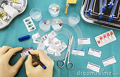 Nurse preparing hospital medication, Write sick data to medical assignment labels Editorial Stock Photo