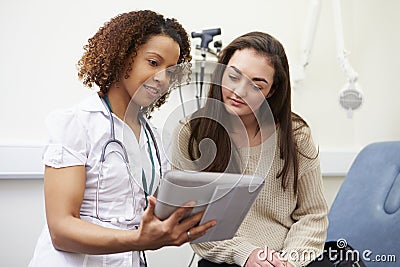 Nurse Showing Patient Test Results On Digital Tablet Stock Photo