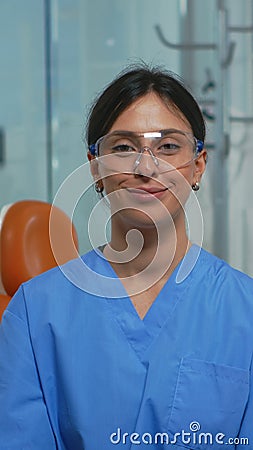 Nurse smiling at camera sitting in dental office Stock Photo