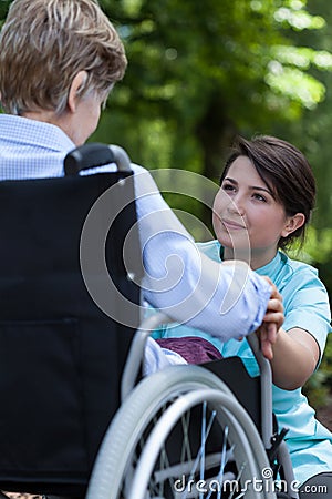 Nurse supports the older a woman with a disability Stock Photo