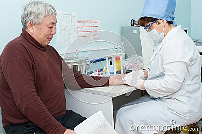 Nurse takes blood specimen for test Editorial Stock Photo