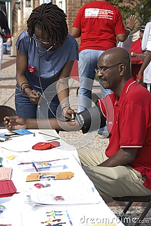 A nurse takes a man blood pressure Editorial Stock Photo