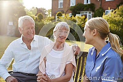Nurse Talking To Senior Couple In Residential Care Home Stock Photo