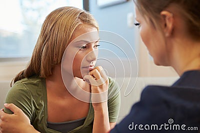 Nurse Treating Teenage Girl Suffering With Depression Stock Photo