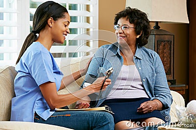 Nurse Visiting Senior Female Patient At Home Stock Photo