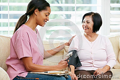 Nurse Visiting Senior Female Patient At Home Stock Photo