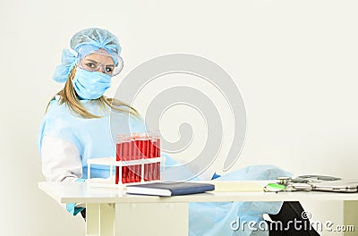 Nurse work in laboratory. search infection remedy for treatment. make virus test. Take a blood test. Donate blood for Stock Photo