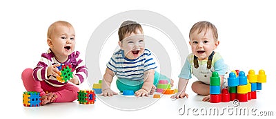 Nursery babies playing with color toys isolated on white background Stock Photo