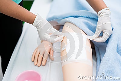 Nursing student were trained how to wound care patient. She practice training with the Doll of patient, Before treatment to the re Stock Photo