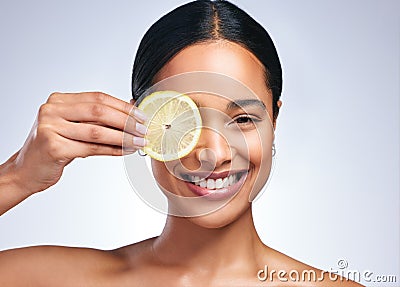 Nurture your intellect. Portrait of an attractive young woman posing with a sliced lemon against a grey background. Stock Photo