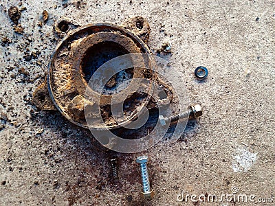 Nut and old metal equipment on dirty ground after used in work hard for a long time Stock Photo