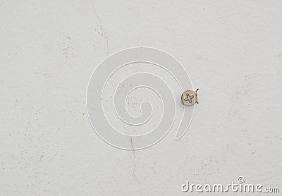 Nut drill on white cement wall for mobile some object Stock Photo