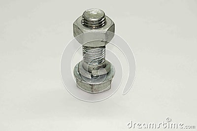 Nut screwed on a bolt, an object made of steel Stock Photo