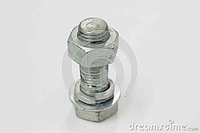 Nut screwed on a bolt, an object made of steel Stock Photo