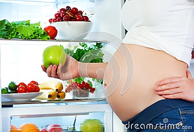 Nutrition and diet during pregnancy. Pregnant woman with fruits Stock Photo