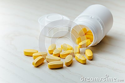 Nutrition supplements, yellow multivitamin pills Stock Photo