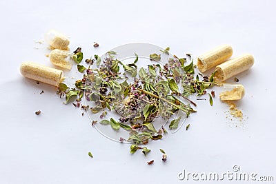 Nutritional supplements pills and capsules on dried herbs background. Alternative herbal medicine, naturopathy and homeopathy Stock Photo