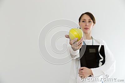 Nutritionist doctor holding scales and apple.Dieting, healthy lifestyle and nutrition concept Stock Photo