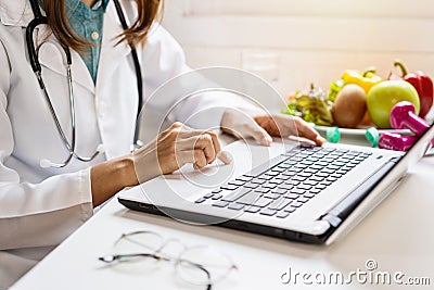 Nutritionist giving consultation to patient with healthy fruit and vegetable, Right nutrition Stock Photo