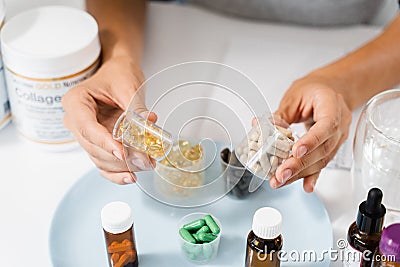 Nutritionist holding in hands omega 3 and vitamin D biologically active additives BAA. Dietary Supplements for correct Stock Photo