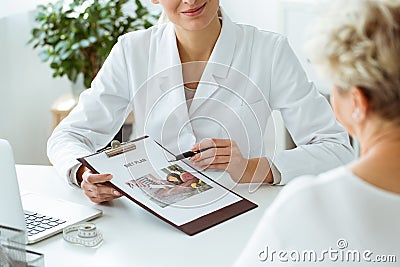 Nutritionist holding personalized diet plan Stock Photo