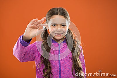 Nutritious diet help body from the inside out. Girl with long hair hold pill fingers. Vitamin concept. Need vitamin Stock Photo