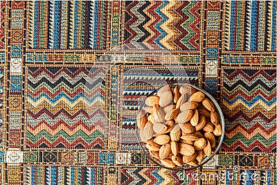 Nuts almonds on a carpet Stock Photo