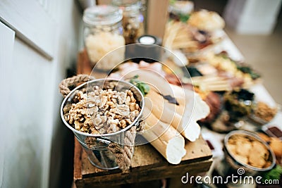 Nuts in bucket on a wedding buffet table snacks Stock Photo